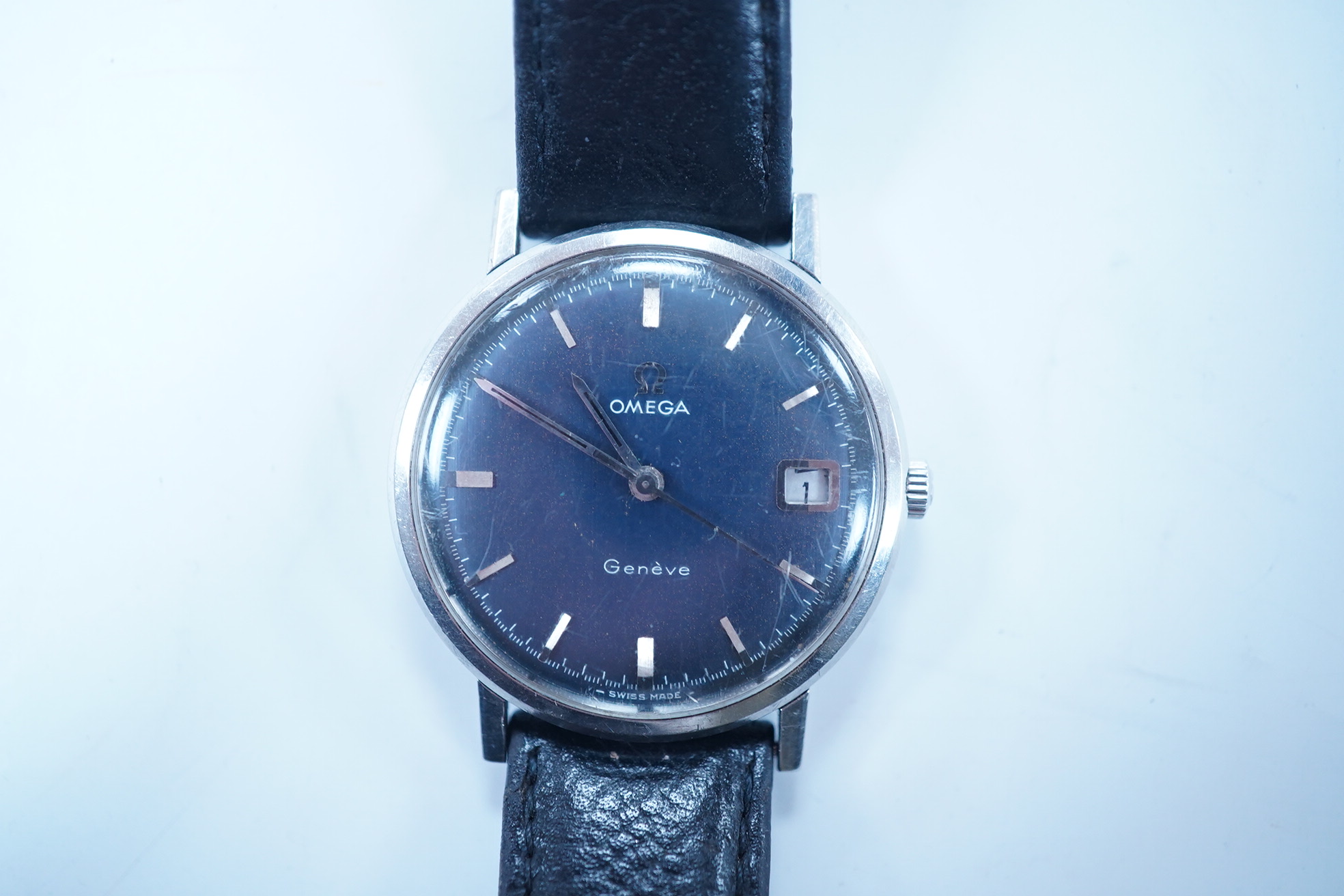 A gentleman's late 1960's stainless steel Omega manual wind wrist watch, with baton numerals and date aperture, movement c.613, case diameter 34mm, on a later associated leather strap. Condition - poor to fair